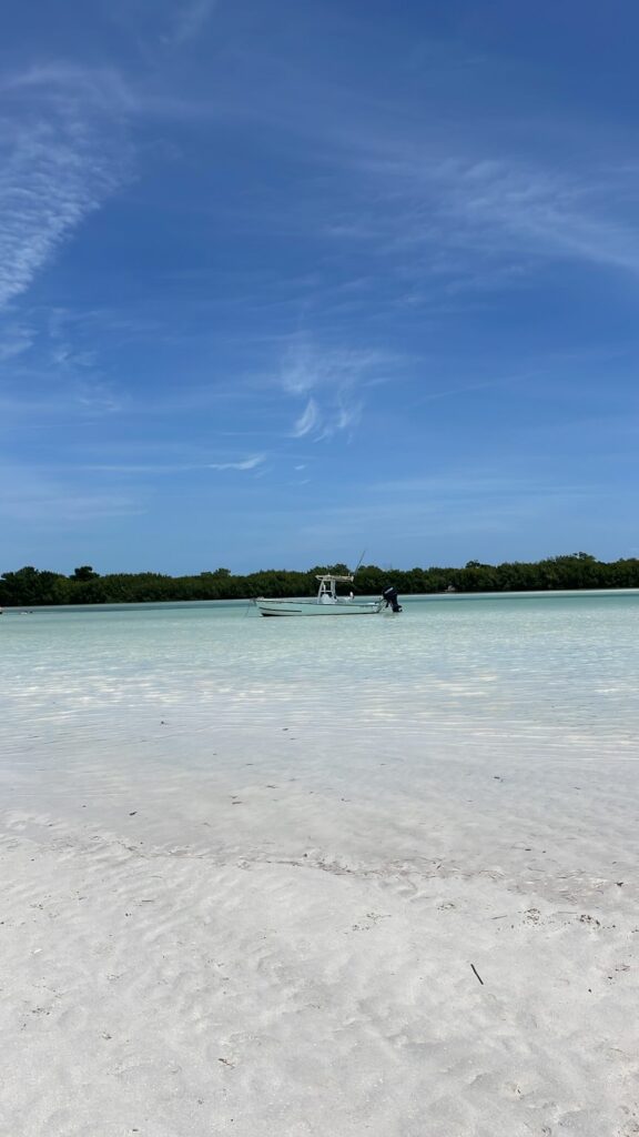 Charter boat anchored in clear, shallow Naples water