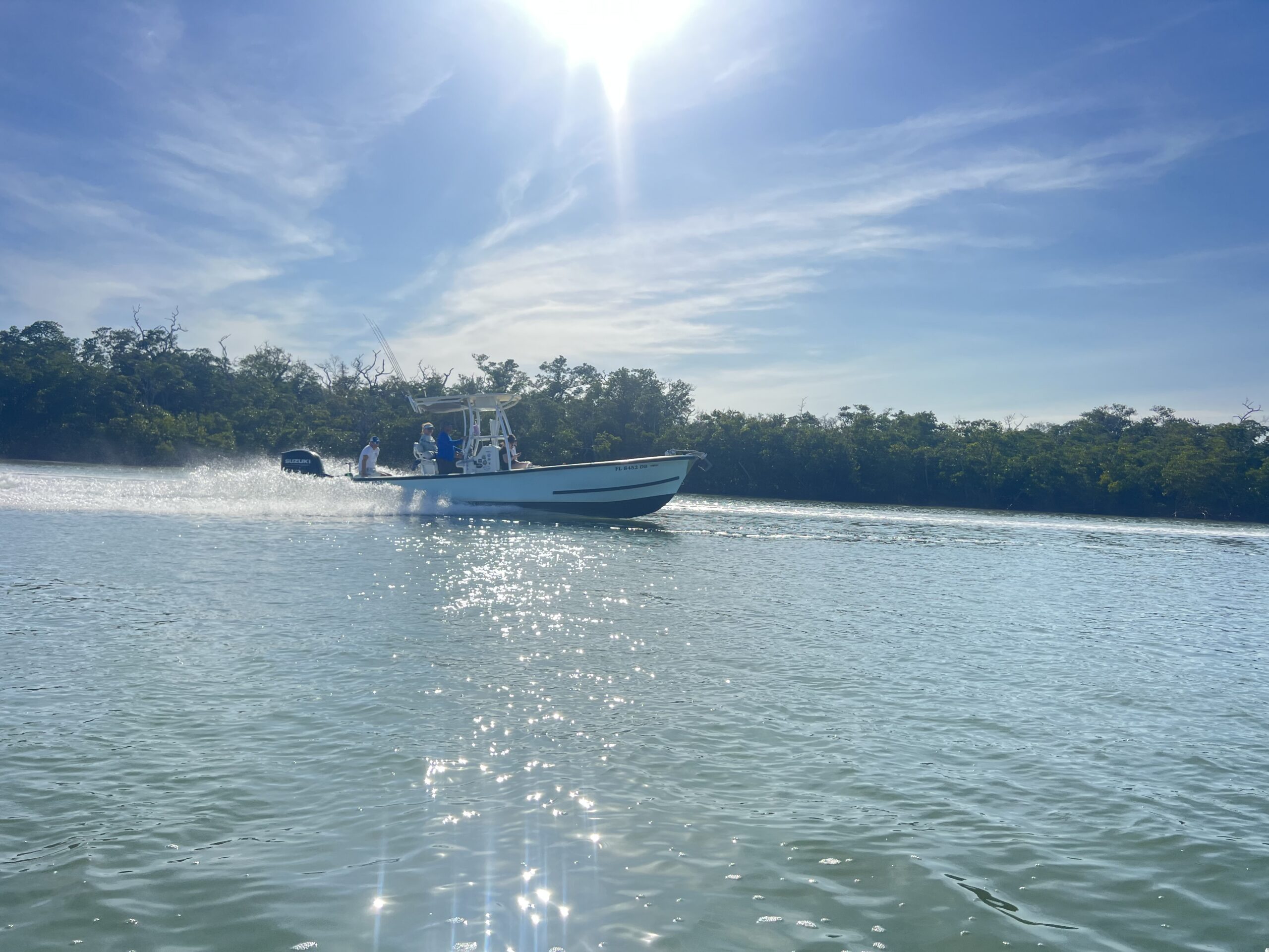 Naples charter boat running across bright Southwest Florida water